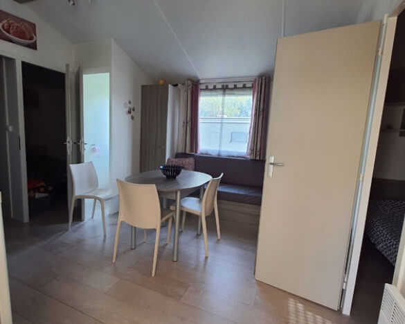 Living/dining room of a mobile home for rent at Le Grand Marais campsite on the Opale Coast